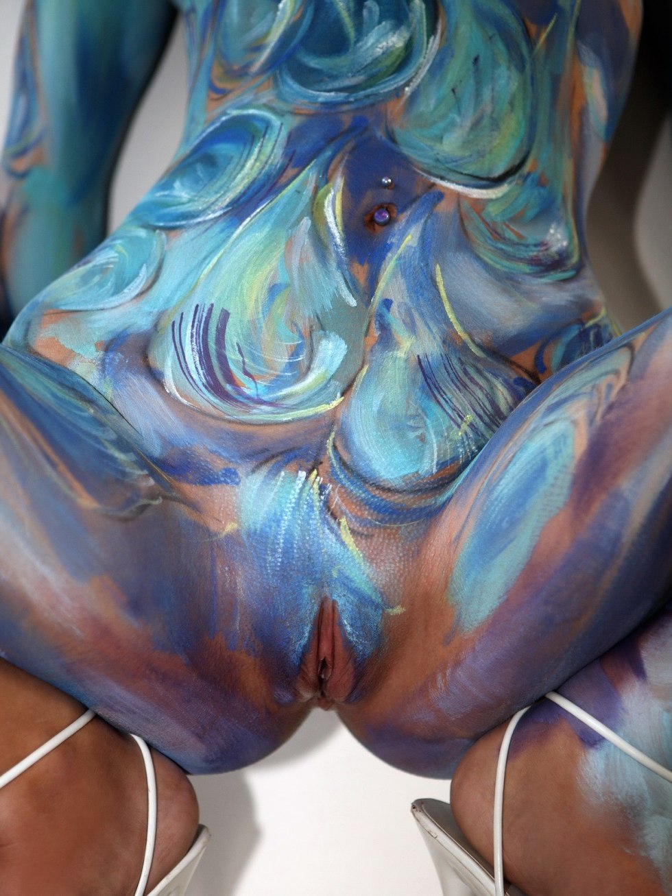 Naked female bodies painted with paints