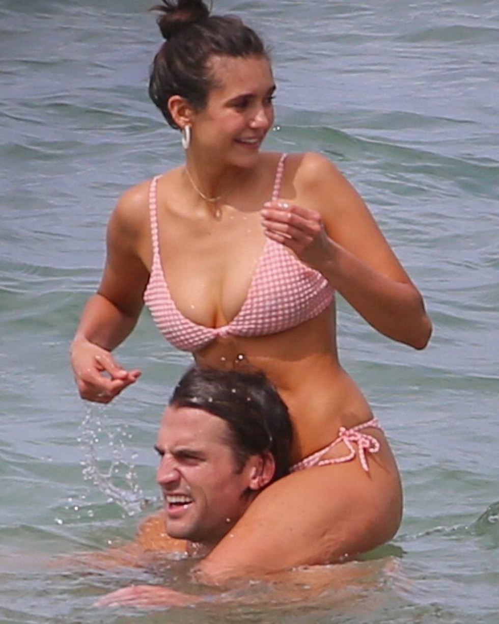 Nina Dobrev and Candice Akol on the beach