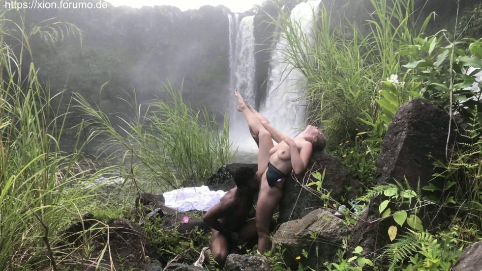 Naked women on stones near the waterfall Naked women
