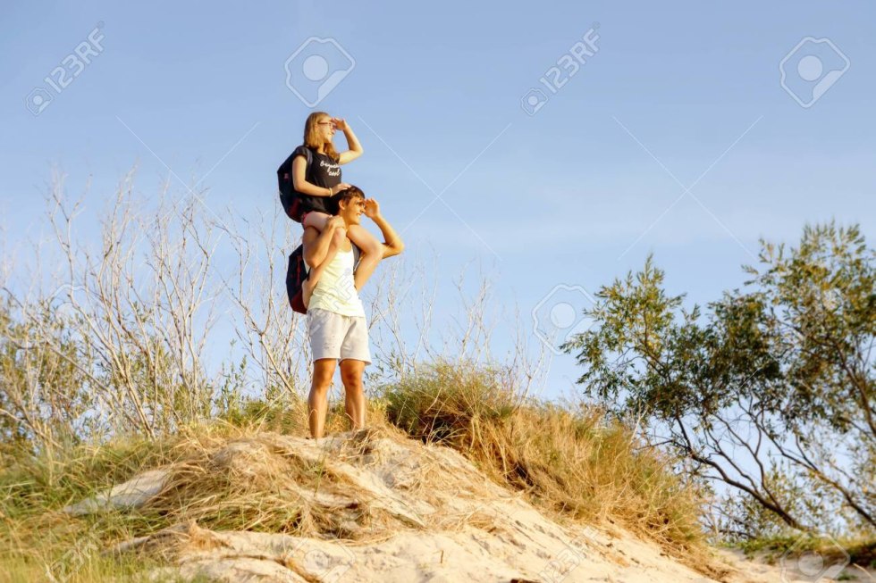 Girl sits on a man's neck
