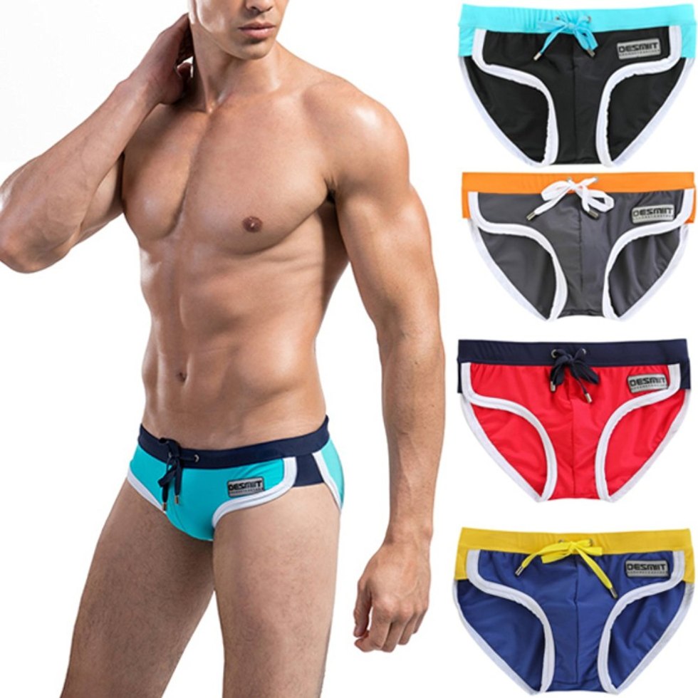 Men in swimming trunks on the beach