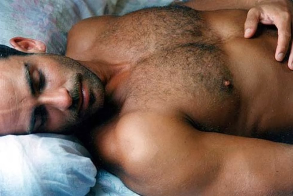 A naked hairy man sleeps