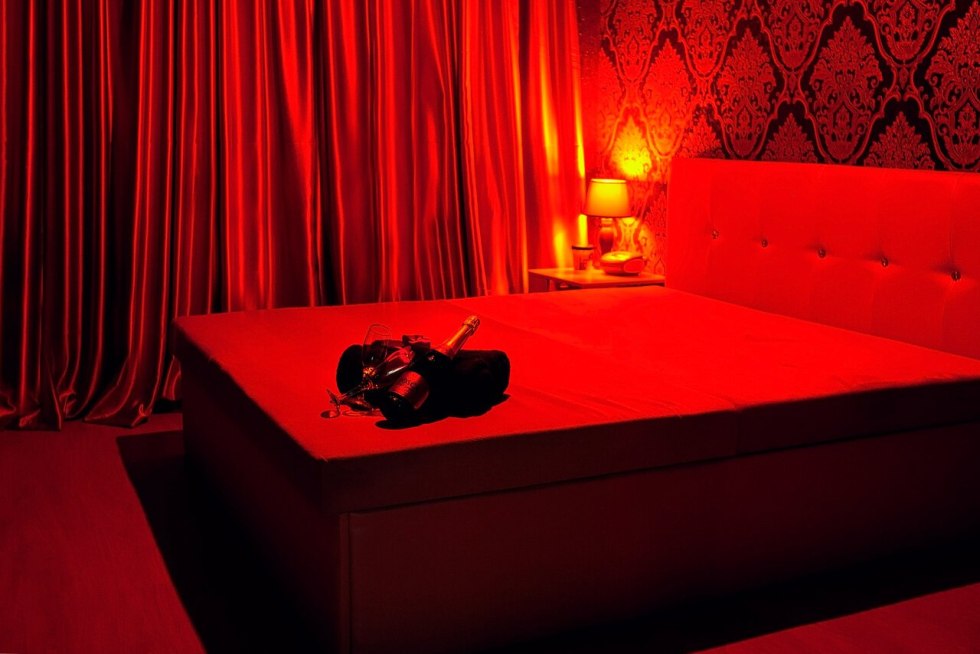 A girl in underwear does a massage to a man